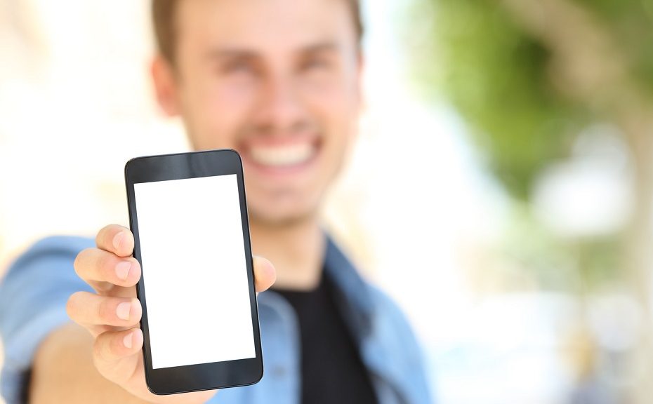 Man showing a blank phone screen in the street